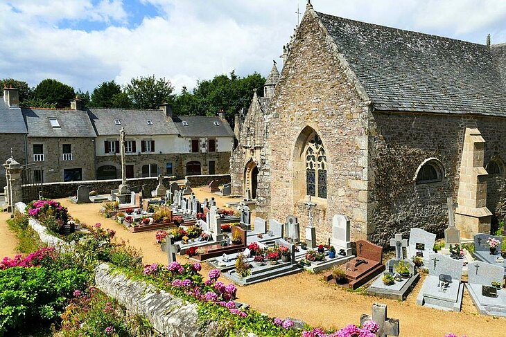 Lanloup Church Lanloup Church and its flower-filled cemetery, a testament to Breton cultural and architectural heritage.
