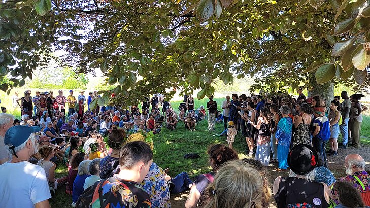 Audience gathered under the trees for a concert at the « À Travers Chants » festival in Rochefort-en-Terre, a must-attend event to experience the village in a unique way.