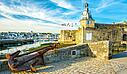 The historic citadel and port of Concarneau under a blue sky.