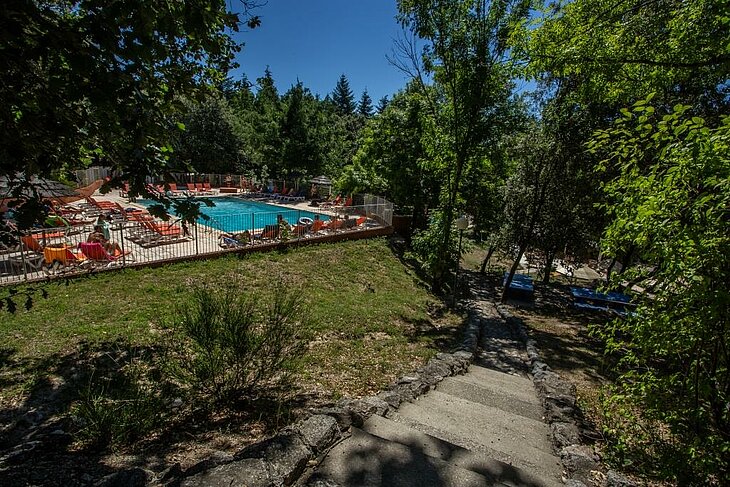 Sunny pool in the heart of the forest at La Marette campsite in Joannas, perfect for a nature holiday in Ardèche.
