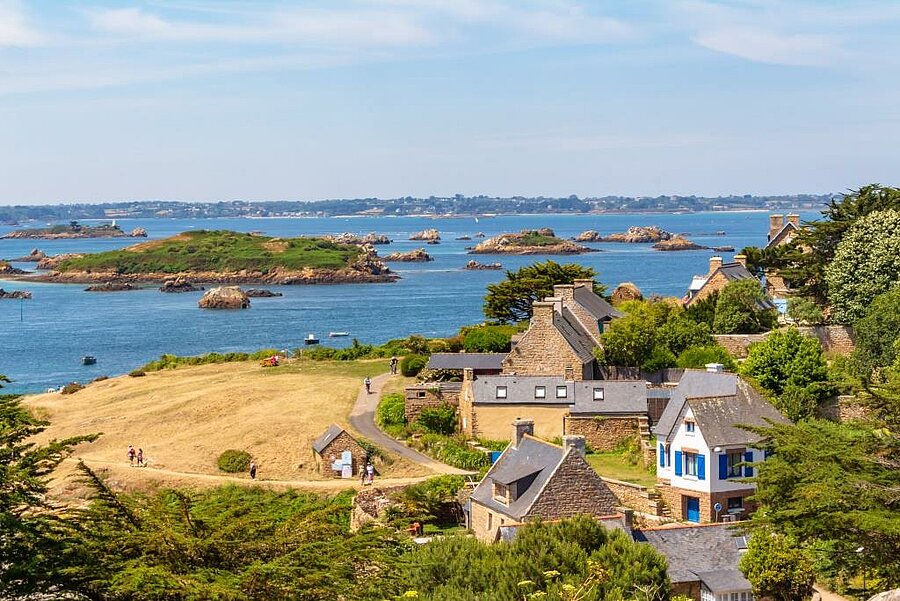 View of Bréhat Island near Paimpol, stone houses and green islets surrounded by the turquoise sea of northern Brittany.