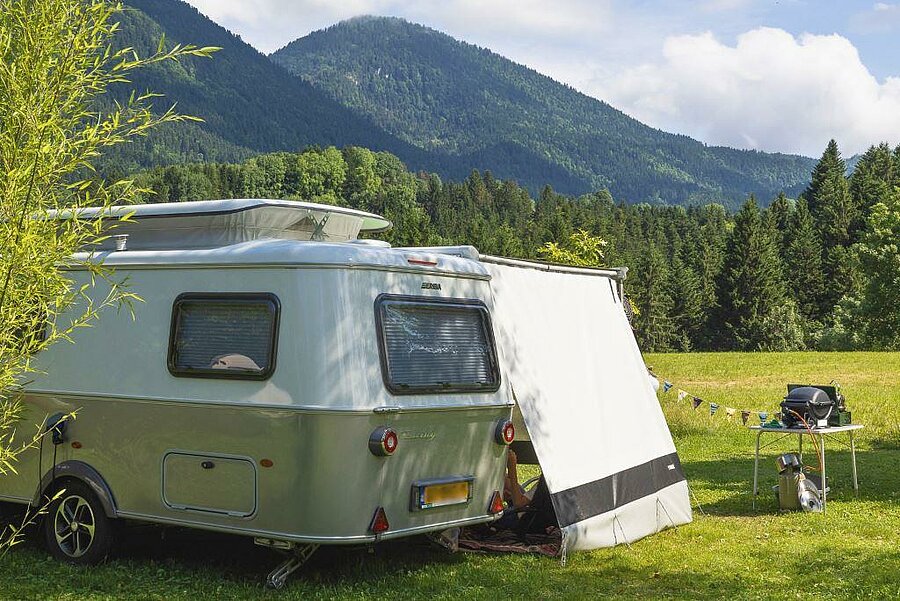 Campsite van parked on a van pitch with views of the Alps, surrounded by nature—perfect for a peaceful and rejuvenating stay.