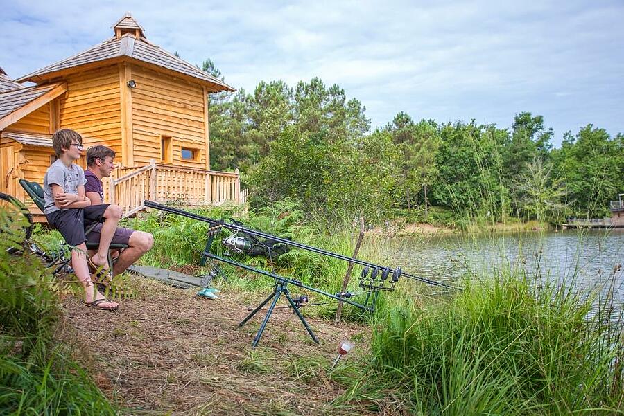 Father and son fishing by the lake