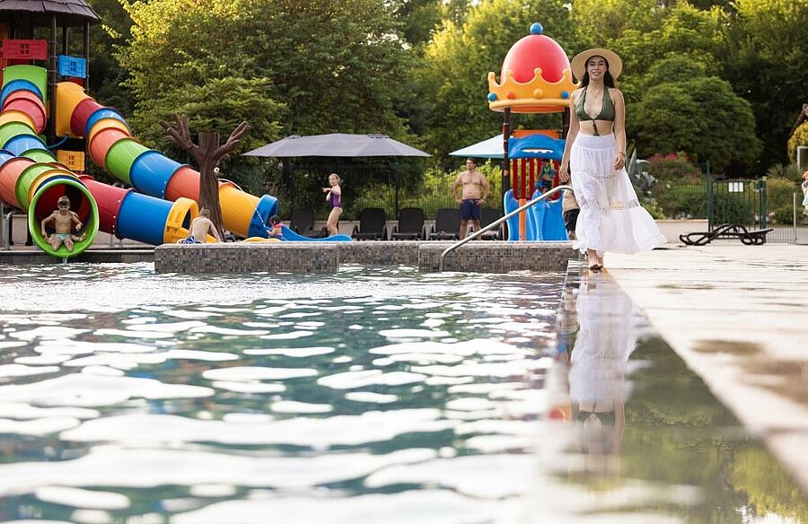 Children playing near a mobile home in a family-friendly Pyrenees campsite, perfect for nature-filled holidays