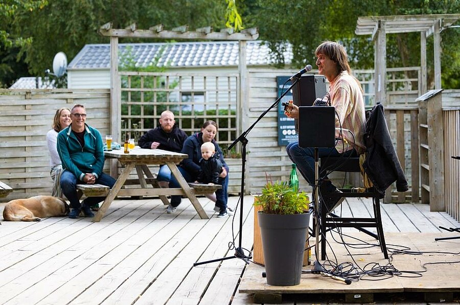 Outdoor concert at a campsite near Paimpol, families enjoying live music in a relaxed holiday setting.