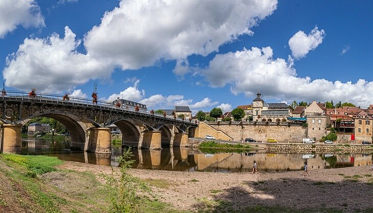 View of Le Bugue on the Banks of the Vézère View of Le Bugue on the banks of the Vézère River, featuring its bridge, quays and town centre houses in the Dordogne.
