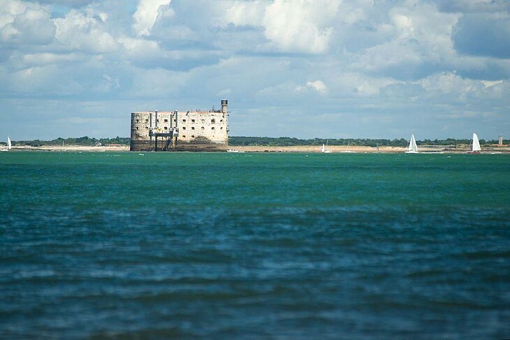 Fort Boyard surrounded by the Atlantic Ocean with sailboats near Île d’Oléron.