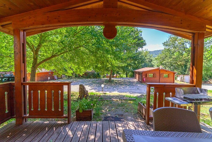 View from the terrace of a wooden chalet at a Sites et Paysages campsite, perfect for a relaxing stay during the May bank holiday.