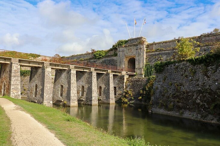 Stone ramparts of Château d’Oléron citadel along the marshes, historic landmark on Île d’Oléron.