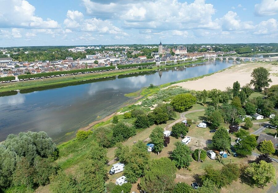 Aerial view of a green riverside campsite near the Sologne, facing the town of Gien and its iconic bridge
