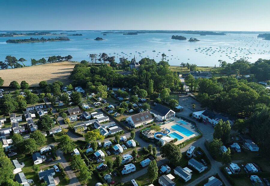 Aerial view of a 4-star campsite with pool near the French coastline and islands.
