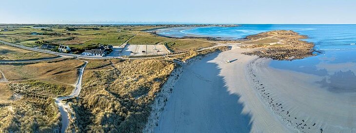Aerial view of the Pointe de la Torche in Plomeur, an iconic natural site in Brittany where sandy beaches meet the Atlantic Ocean.