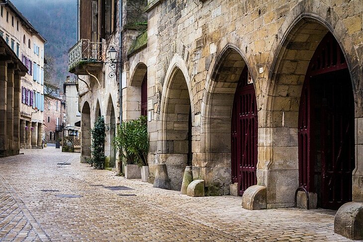 Historic centre of Saint-Antonin-Noble-Val Cobbled street in the historic centre of Saint-Antonin-Noble-Val, lined with old houses and stone archways.