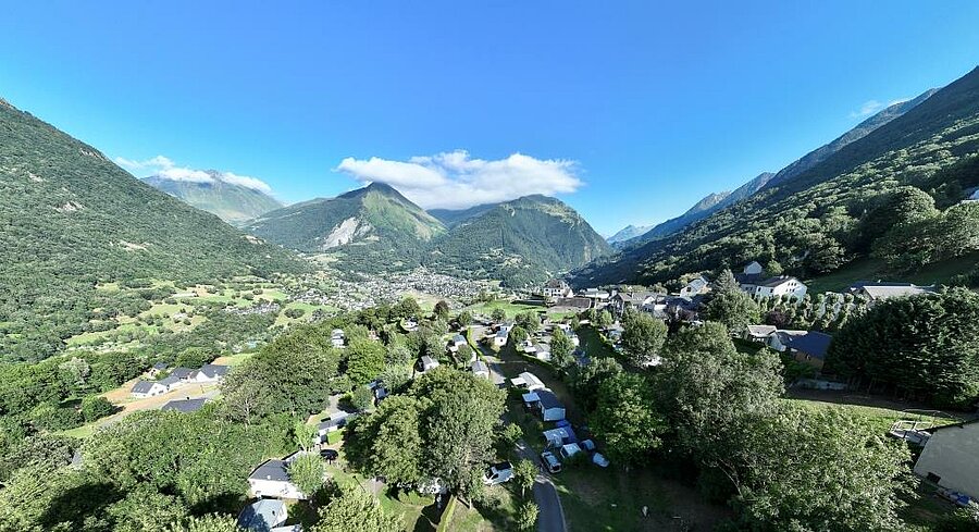 Aerial view of Luz-Saint-Sauveur nestled in a Pyrenees valley, a mountain village to explore during a Camping Luz-Saint-Sauveur stay.