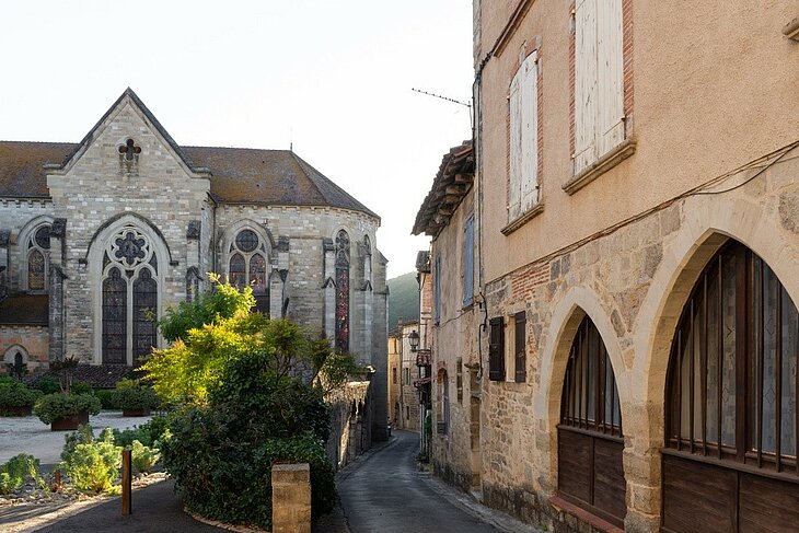 Saint-Antonin-Noble-Val’s heritage and historic centre Street in the historic centre of Saint-Antonin-Noble-Val, lined with stone houses, with Saint-Antonin Church in the background.