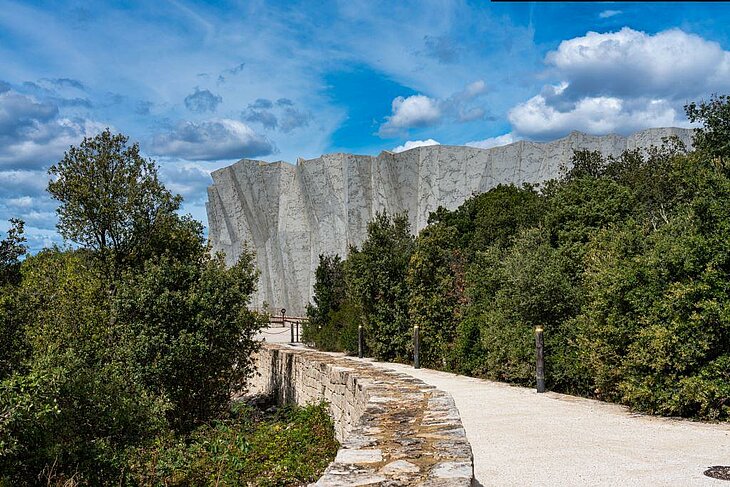Monumental entrance of Grotte Chauvet 2 surrounded by forest, a major cultural site to visit around Joannas.