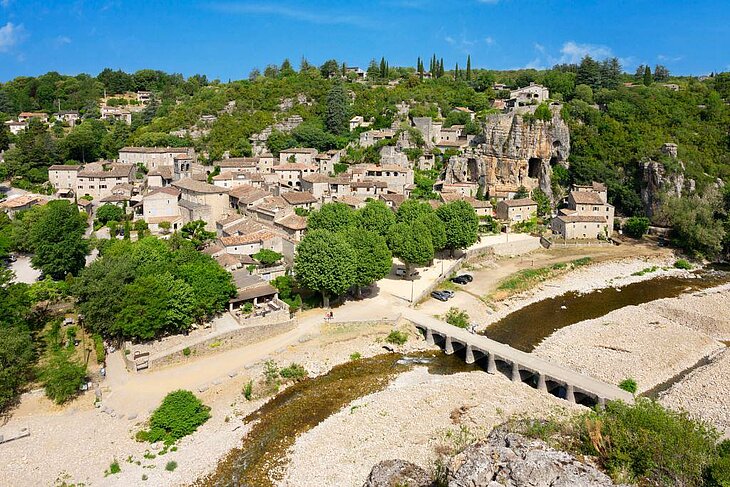 View of Labeaume with its stone houses nestled beneath the cliffs, along the river, near Joannas in Ardèche.
