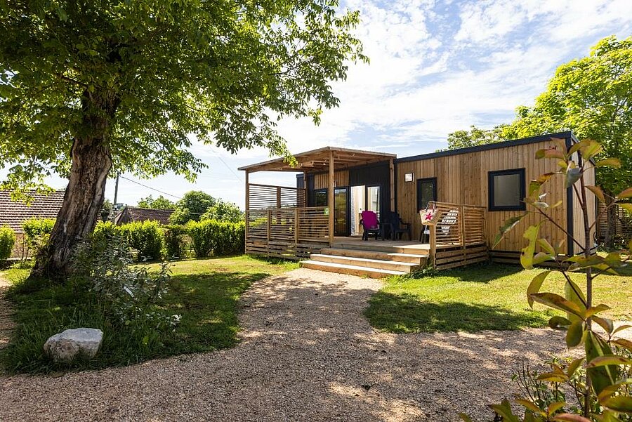 Spacious wooden mobile home with shaded terrace, ideal for a nature holiday in a campsite in the Lot.