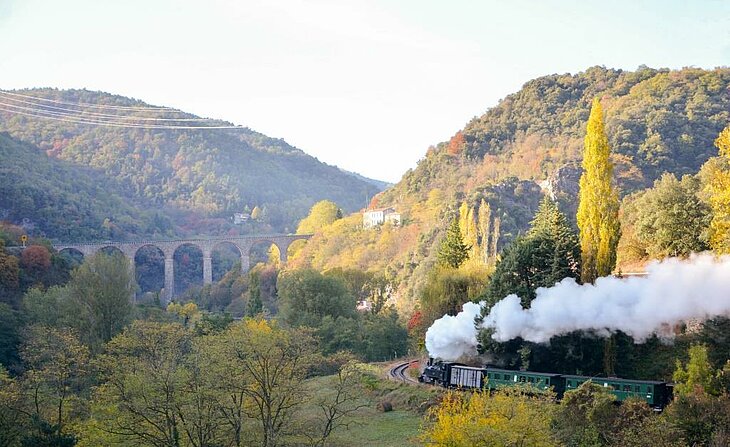 Steam train travelling through the Doux Gorges in the Ardèche, a family-friendly experience at the heart of the region’s spectacular natural landscapes.