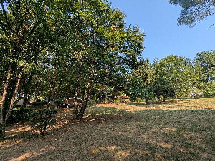 Domaine de la Grande Veyière Campsite pitches and accommodation nestled among the trees at Domaine de la Grande Veyière Campsite, near Le Bugue in the Dordogne.