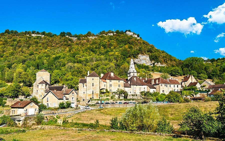 Village of Baume-les-Messieurs beneath the wooded cliffs of the Jura, France, to discover on a camping holiday.