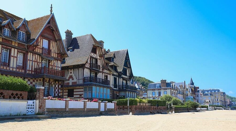 Belle Époque villas overlooking Deauville’s sandy beach, an iconic seaside town to explore during a Camping Deauville stay.
