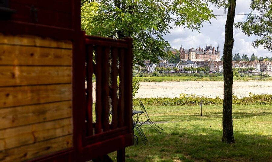 Camping accommodation facing Château de Gien in the Loire Valley, peaceful setting by the river