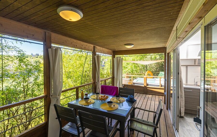 Wooden terrace of a comfortable mobile home at a campsite close to Salavas, perfect for a nature-filled family stay.