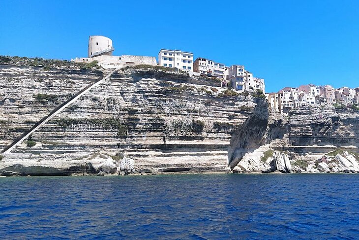The town of Bonifacio, perched on limestone cliffs above the sea, is an iconic historic site to visit when planning what to do in Corsica.