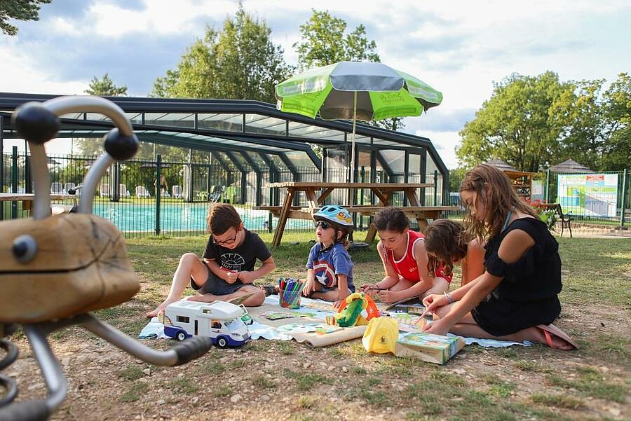 Children playing together near the campsite pool