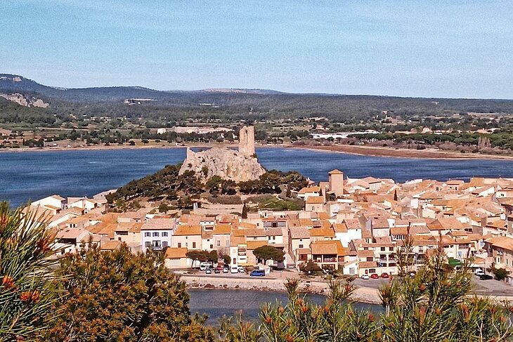 View of the village of Gruissan and the Barberousse Tower overlooking the lagoons, an ideal getaway to combine with a tourism stay in Lézignan-Corbières.