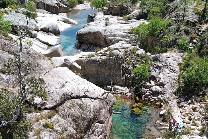 Natural pools in the Cavu Valley, Corsica, with a turquoise river winding through rocks and nature—perfect for planning what to do in Corsica.
