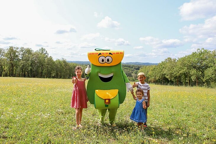 Children with a mascot at a nature campsite, friendly atmosphere for an affordable family holiday.