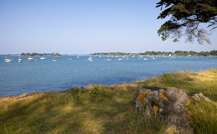 Calm view of the Gulf of Morbihan in Arradon with anchored sailboats, perfect for a sunrise walk and discovering Arradon tourism.