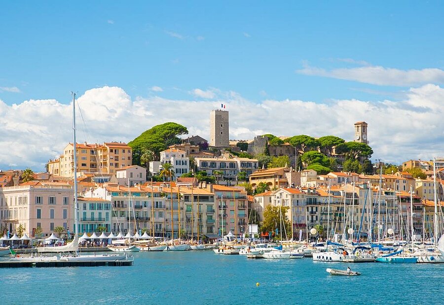 View of Cannes old port and the Suquet district overlooking the Mediterranean Sea, a cultural stop to explore during a Camping Cannes stay.