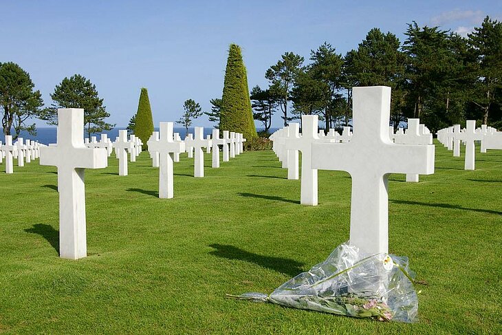 White crosses aligned at the American Cemetery in Colleville-sur-Mer, Normandy, a memorial site facing the sea for a solo visit.