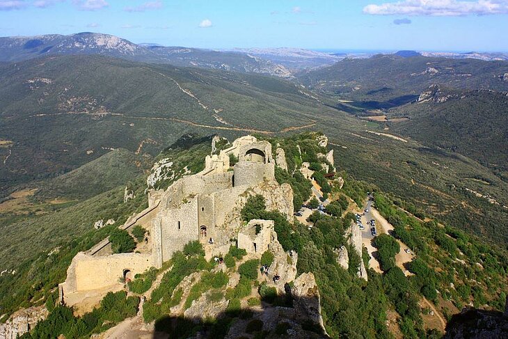 Aerial view of Peyrepertuse Castle nestled in the Corbières, a must-see medieval gem to explore during a tourism stay in Lézignan-Corbières.